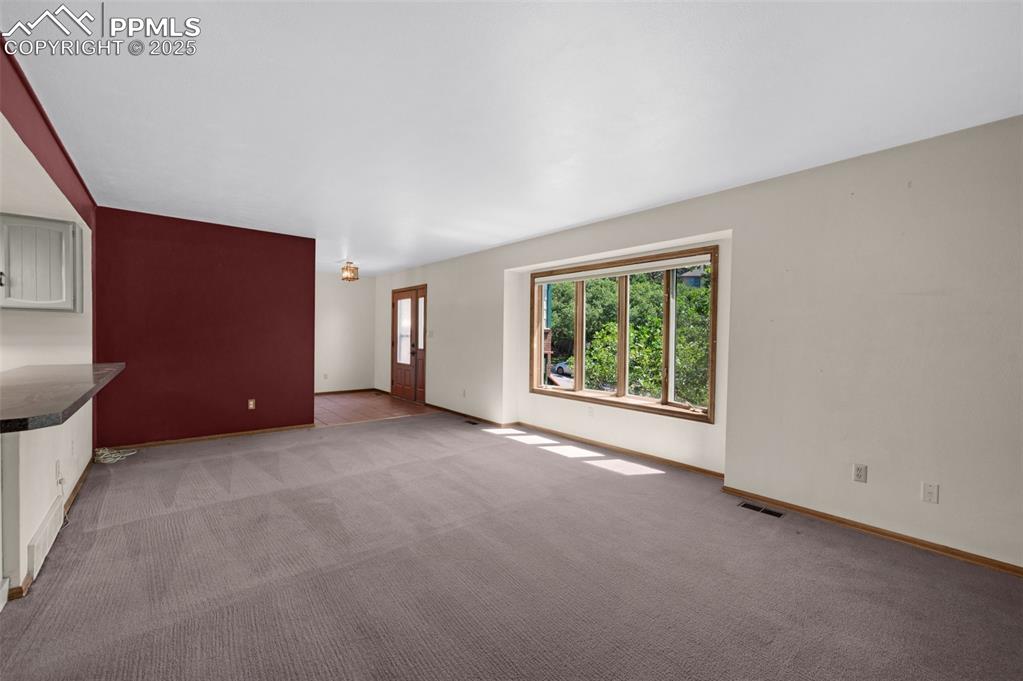 Image 14 of 47: Unfurnished living room with carpet flooring