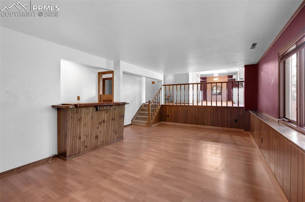 Image 26 of 47: Empty room featuring light wood-style flooring and stairway