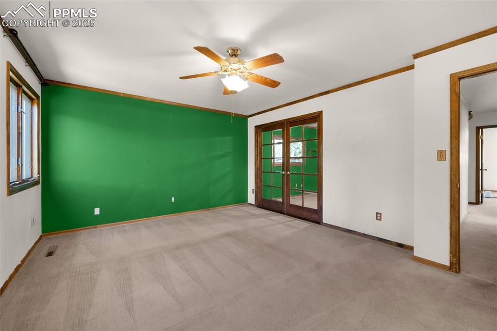 Image 31 of 47: Spare room with carpet flooring, ceiling fan, ornamental molding, and frenc