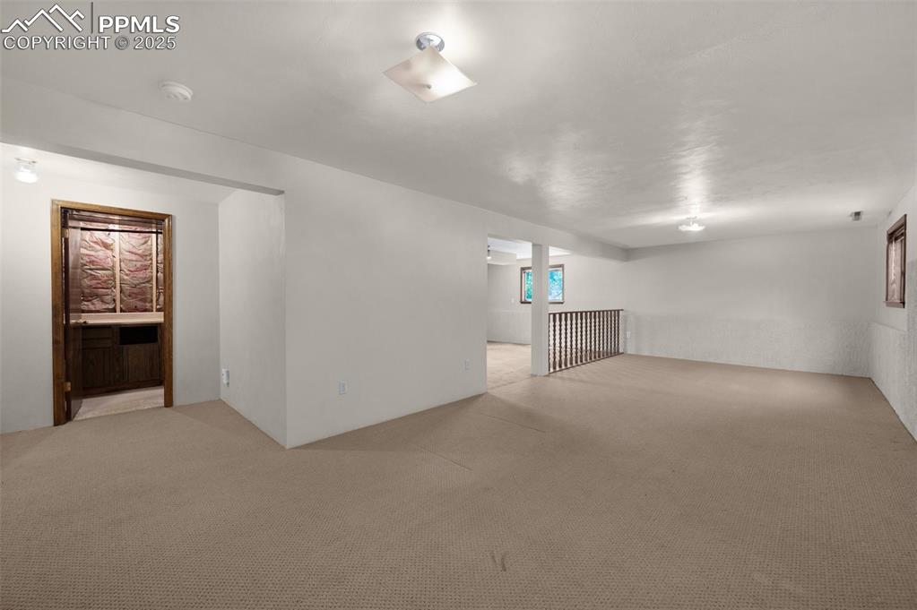 Image 39 of 47: Basement featuring light colored carpet