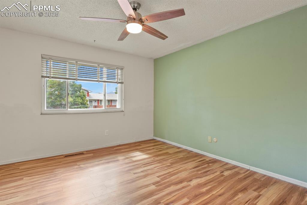 Image 15 of 39: Master Bedroom featuring wood finished floors, a textured ceiling, and ceil
