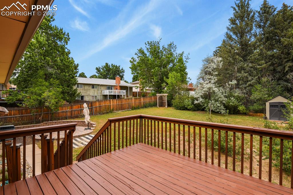 Image 33 of 39: Large wood deck off of dining room/kitchen