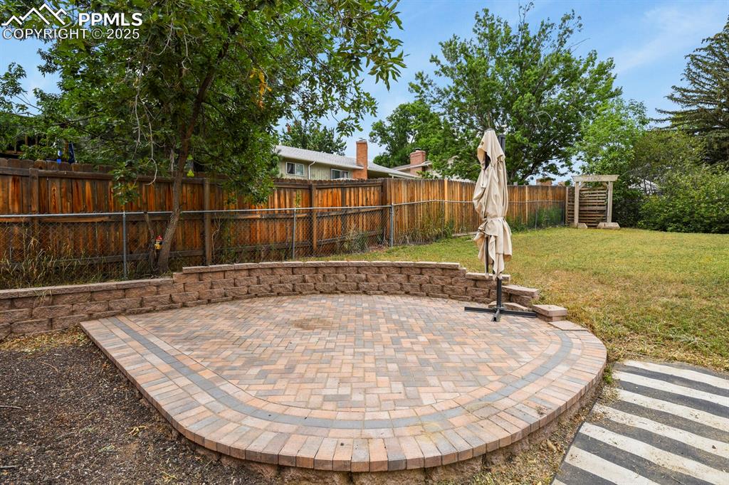 Image 34 of 39: Fenced backyard featuring a patio area