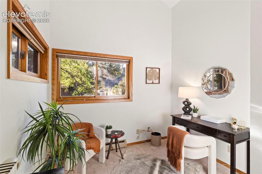 Image 23 of 47: Vaulted ceilings, expansive window openings, and natural wood trim framing
