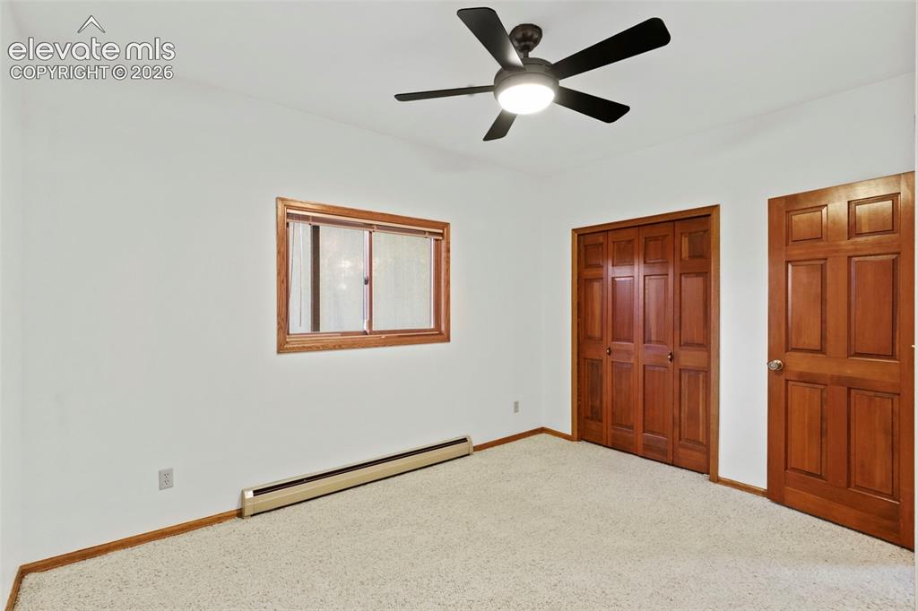 Image 38 of 47: Room featuring neutral carpeting, a five-blade ceiling fan with integrated
