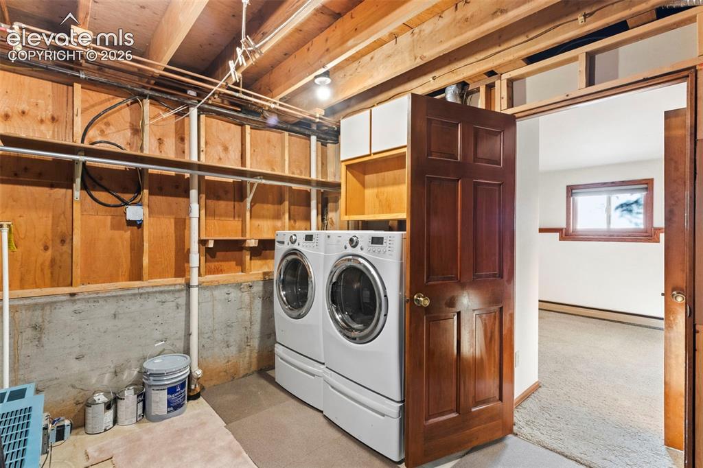 Image 42 of 47: Utility area featuring exposed wood framing, concrete foundation walls, bui