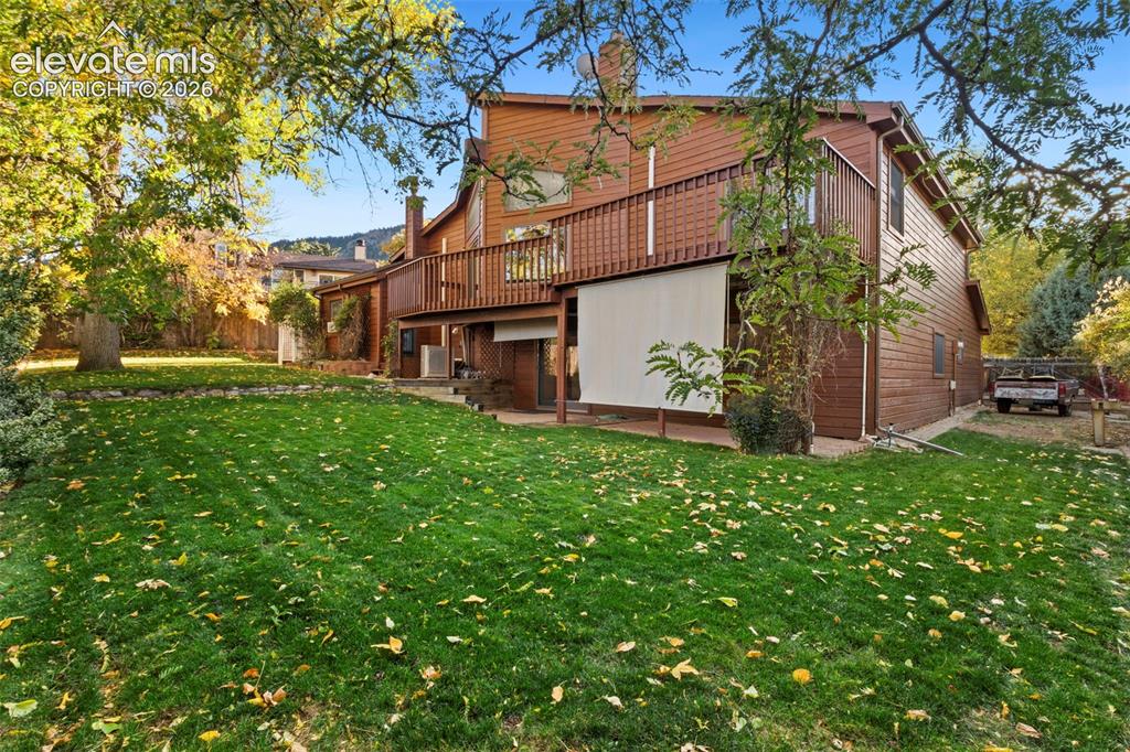 Image 5 of 47: Multi-level exterior featuring wood siding, a second-story wooden deck with