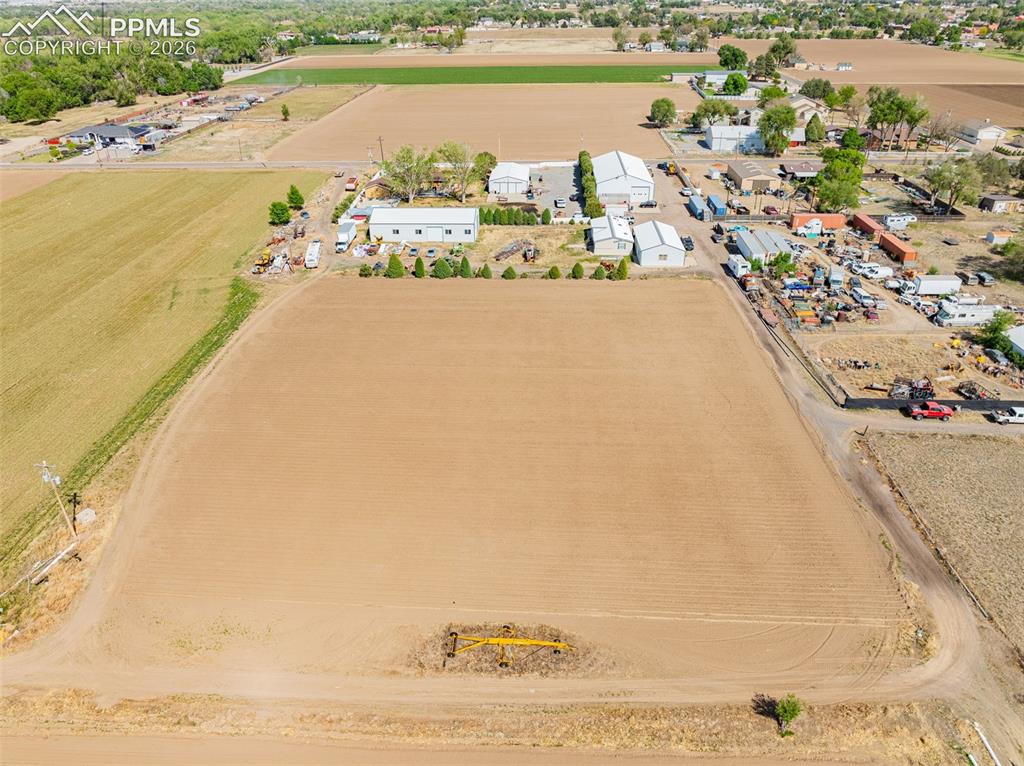 Image 13 of 20: Expansive agricultural land featuring a tilled field, perimeter fencing, an