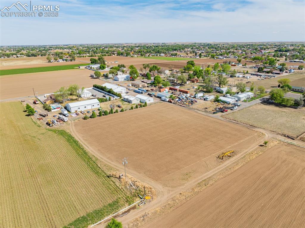 Image 15 of 20: Expansive agricultural land featuring cultivated fields and a rural setting