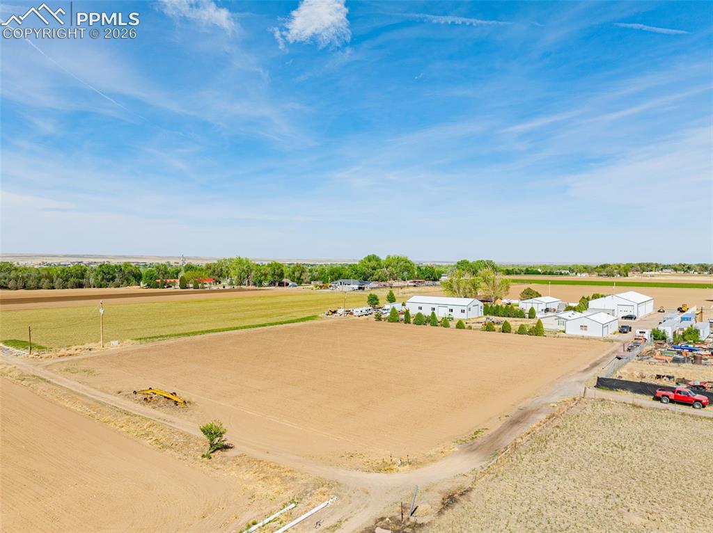 Image 16 of 20: Expansive undeveloped land parcel featuring cultivated earth and perimeter