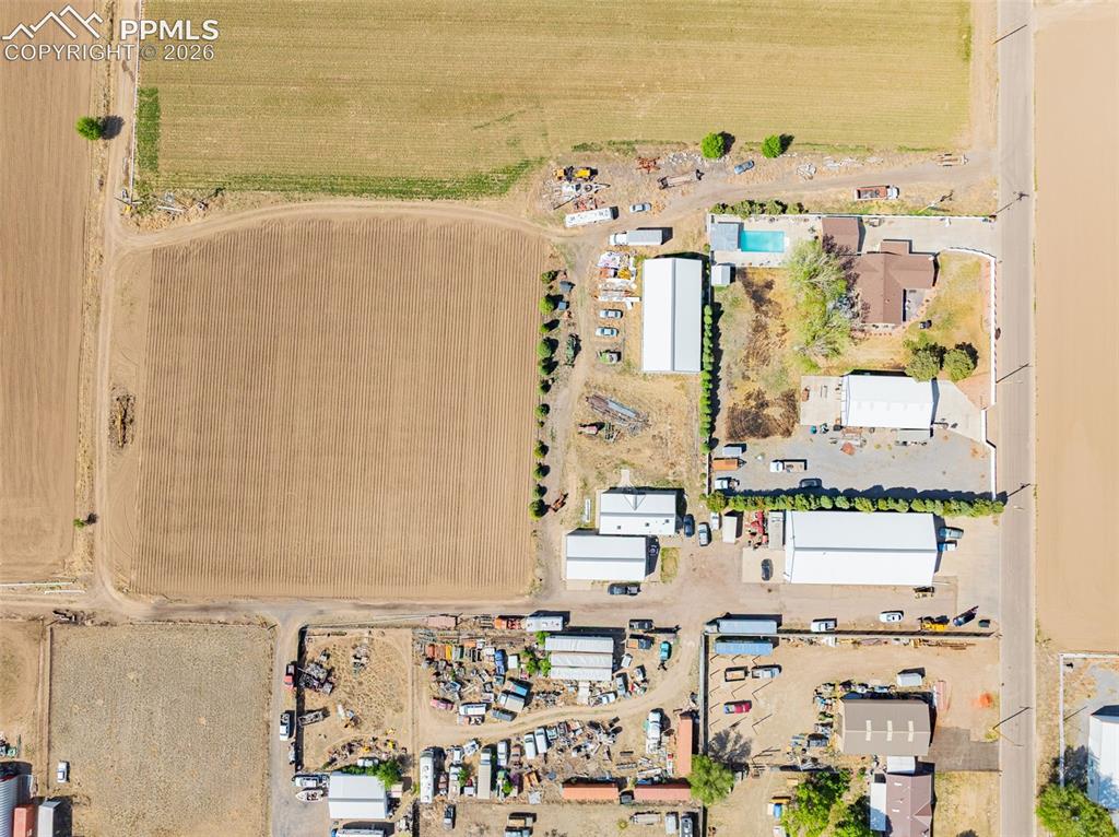 Image 18 of 20: Expansive aerial perspective showcasing a residential dwelling, a rectangul