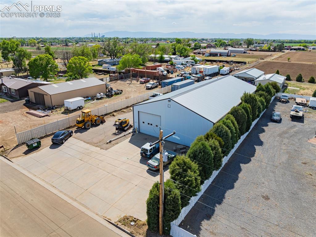 Image 2 of 20: Industrial property featuring a large warehouse building with a roll-up doo