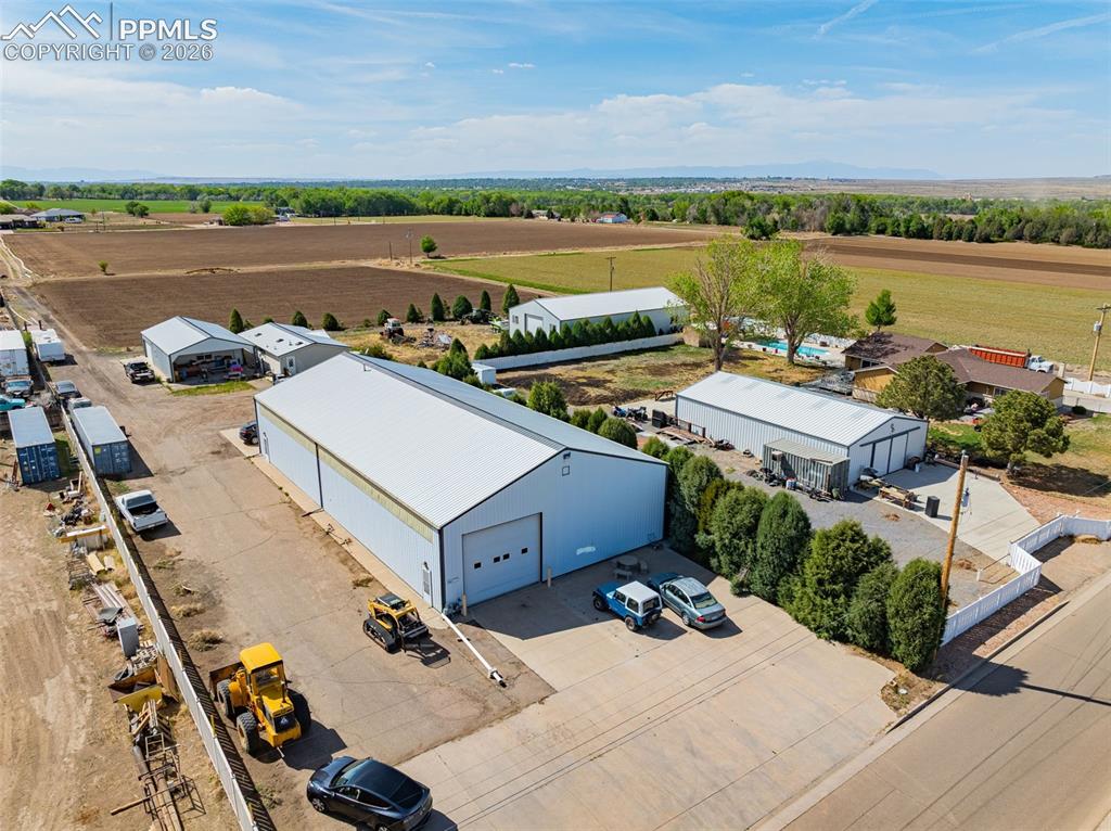 Image 3 of 20: Expansive property featuring multiple large metal buildings with roll-up do