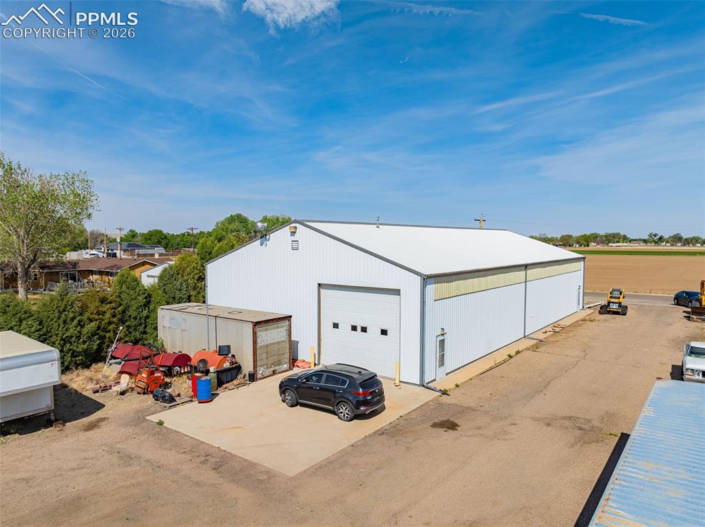 Image 4 of 20: Industrial-style metal building featuring a white corrugated exterior and a