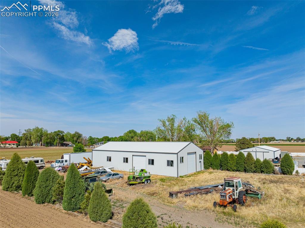 Image 6 of 20: Multiple outbuildings featuring metal siding and roll-up doors, 40x80 Stora