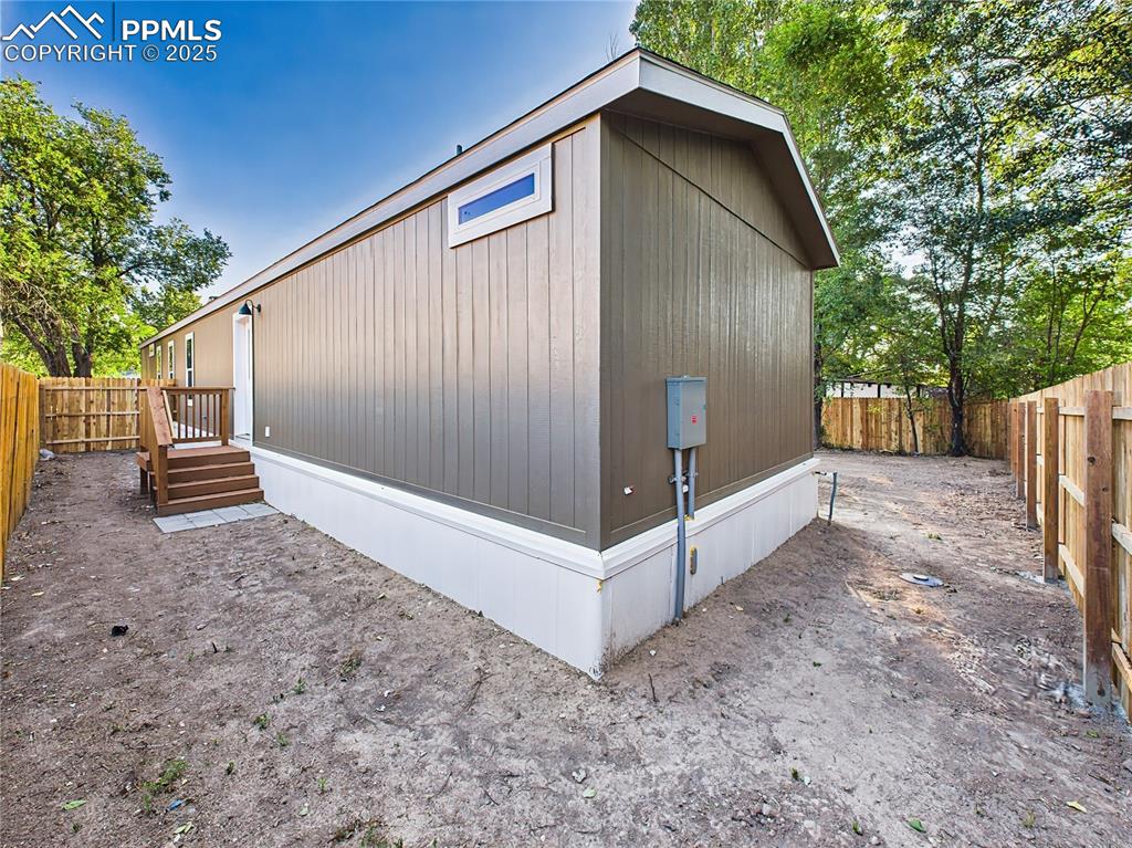 Image 38 of 39: Side Entrance – Additional access point with fenced boundary and easy-to-ma