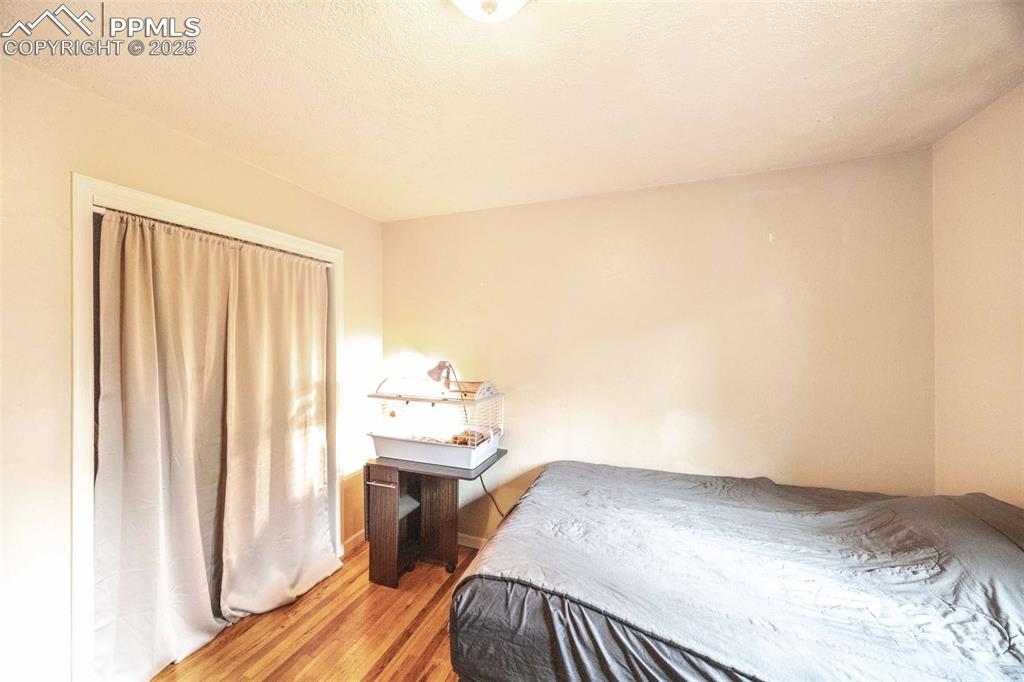 Image 10 of 21: Upstairs bedroom with freshly refinished hardwood floors