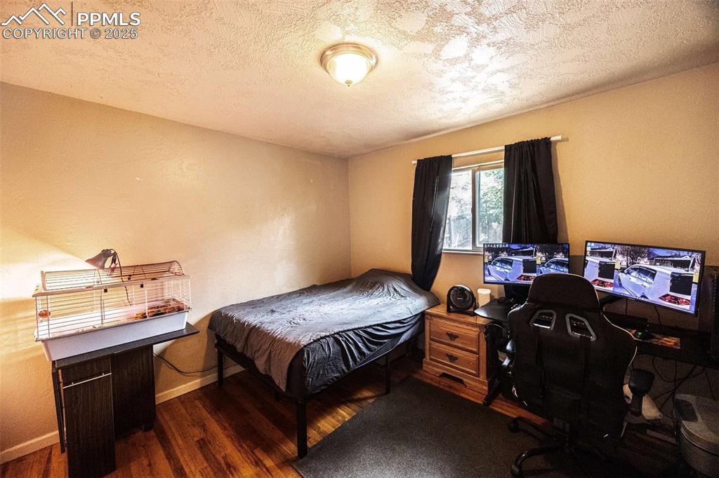 Image 11 of 21: Upstairs bedroom with freshly refinished hardwood floors