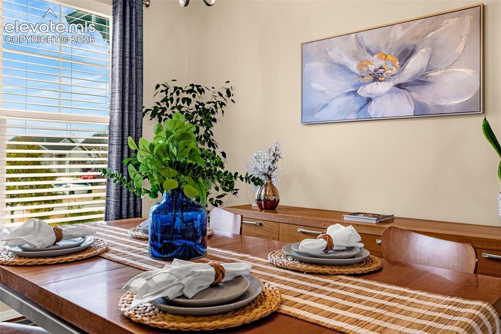 Image 14 of 49: Neutral wall paint, large window with integrated blinds, and polished wood-