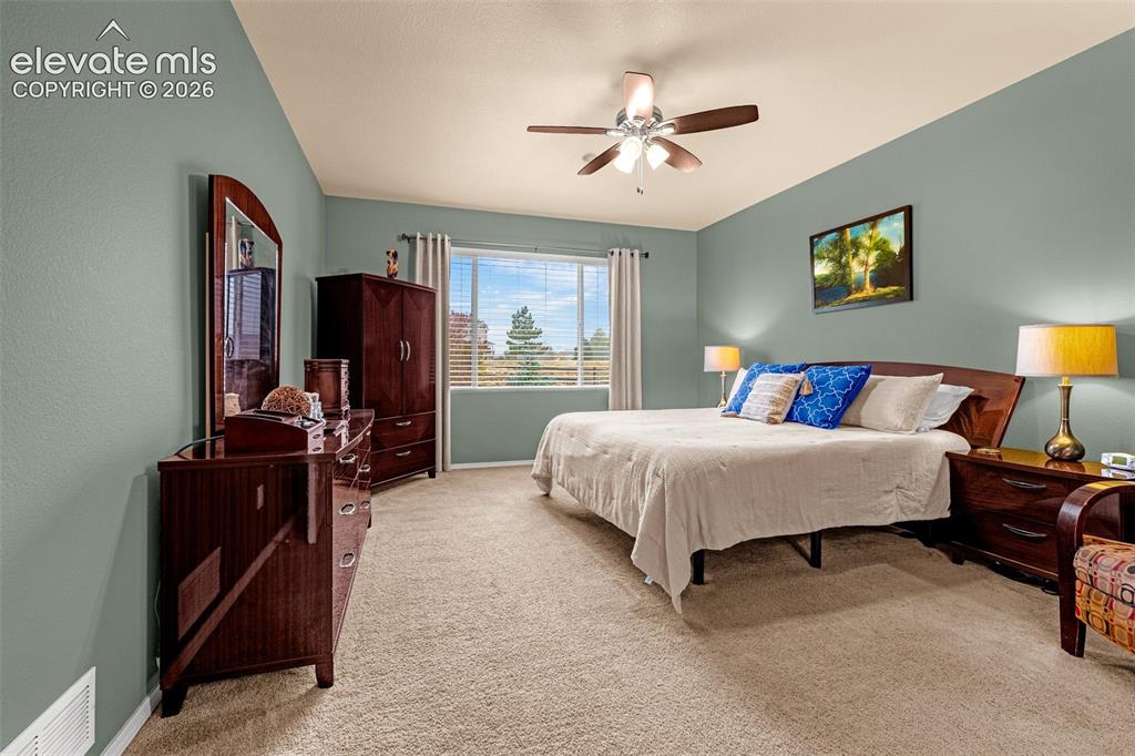 Image 16 of 49: Spacious room featuring neutral carpeting, a dual-tone ceiling fan with int