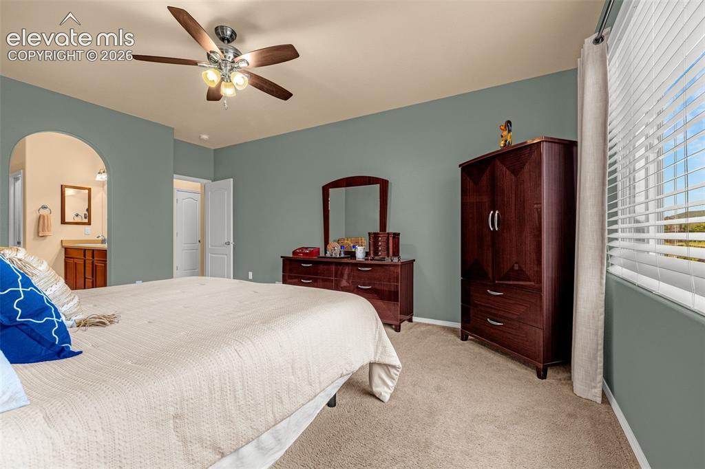 Image 17 of 49: Spacious room featuring neutral carpeting, a central ceiling fan with integ