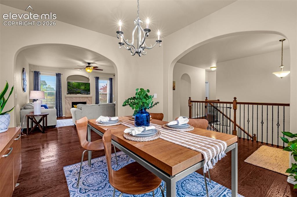 Image 27 of 49: Open-concept interior featuring arched entryways, wood-finish flooring, a m