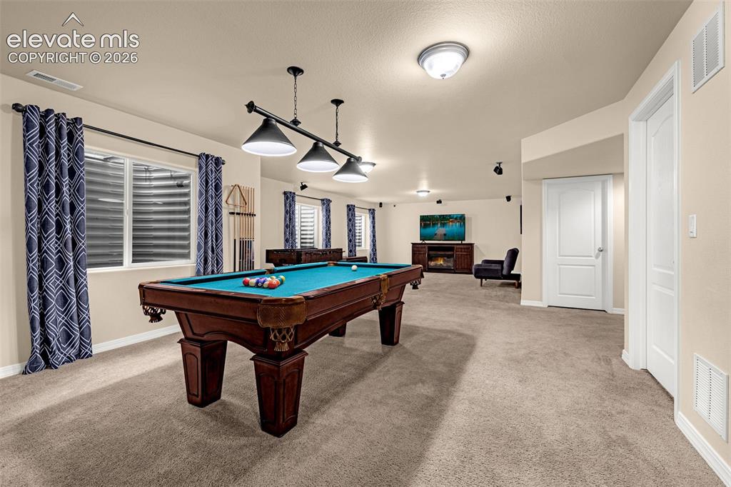 Image 28 of 49: Spacious interior room featuring wall-to-wall carpeting, recessed ceiling l