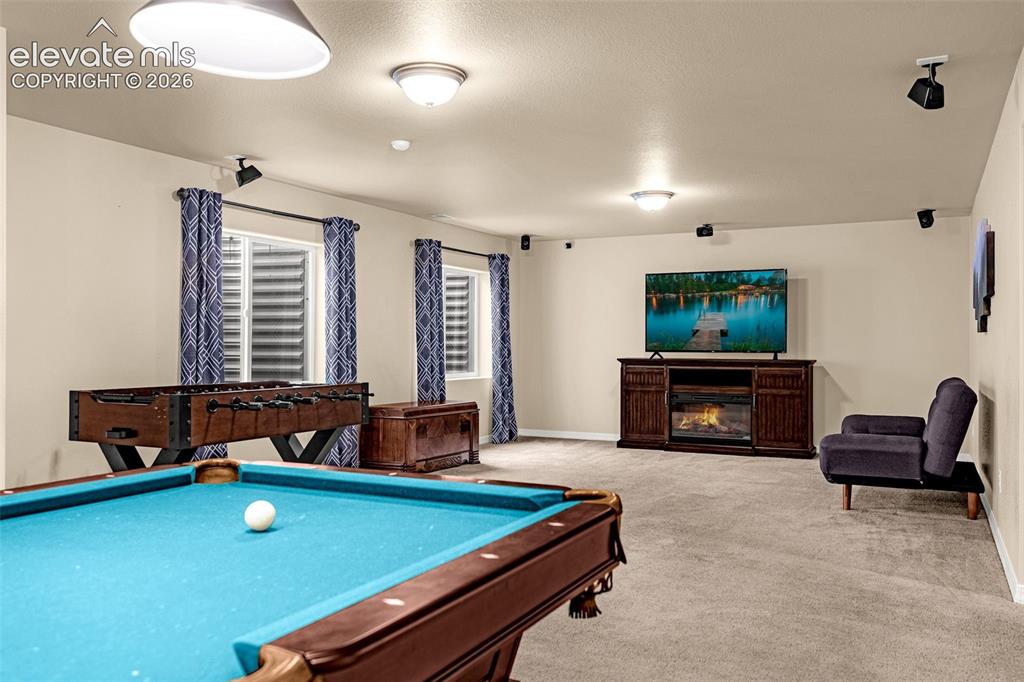 Image 29 of 49: Open interior space with wall-to-wall carpeting, recessed ceiling lighting,