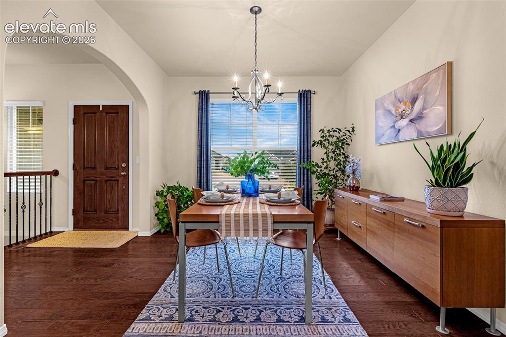 Image 3 of 49: Dining space featuring wood-finish flooring, a multi-arm metal chandelier, 