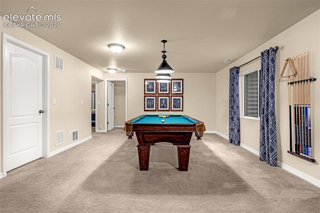Image 30 of 49: Spacious room featuring neutral carpeting, recessed ceiling lighting, a mul