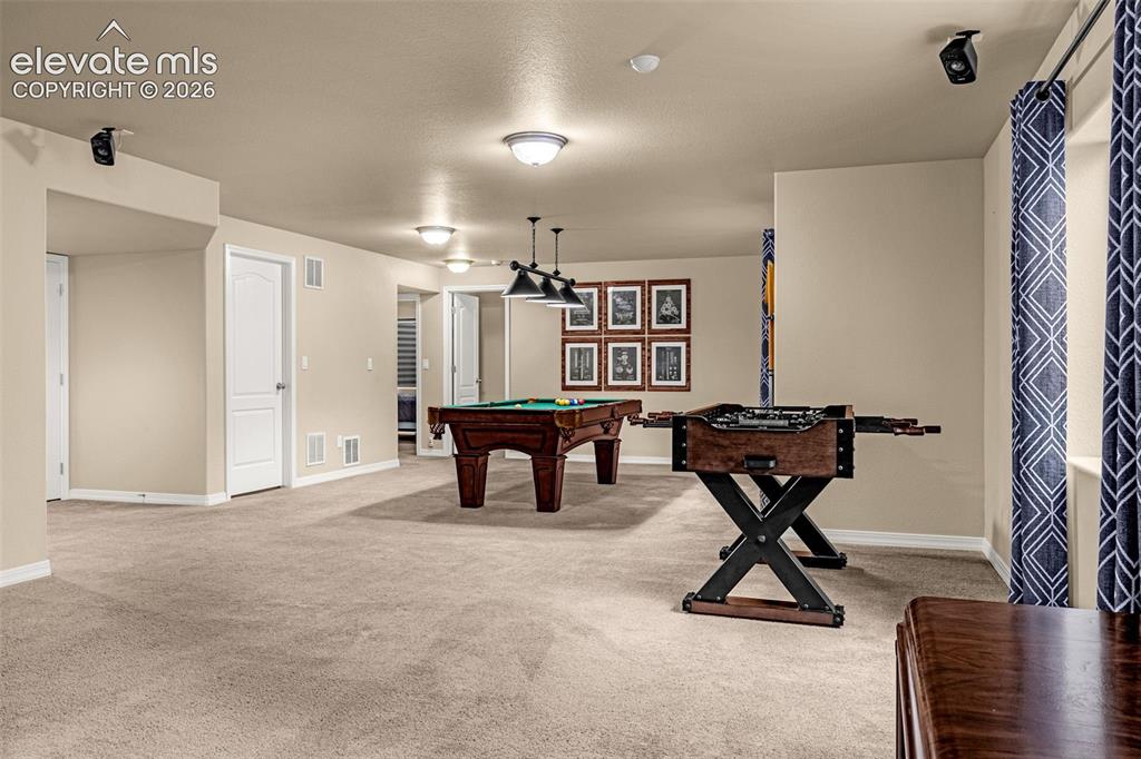 Image 31 of 49: Interior space featuring neutral wall tones, wall-mounted audio speakers, r
