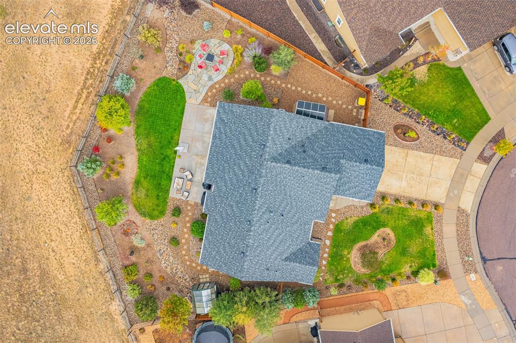 Image 47 of 49: Aerial perspective of residential property featuring a flagstone patio, con