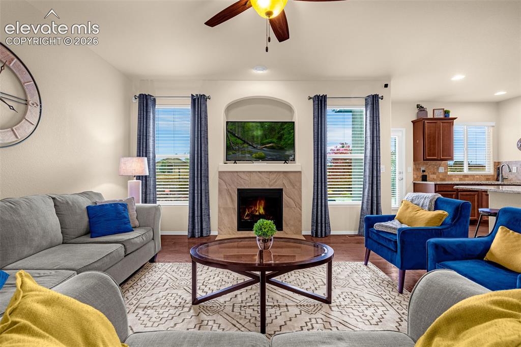Image 7 of 49: Fireplace featuring a stone-tile surround and recessed arched alcove, wood-