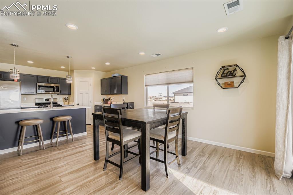 Image 10 of 23: Dining area featuring light wood-style flooring and recessed lighting