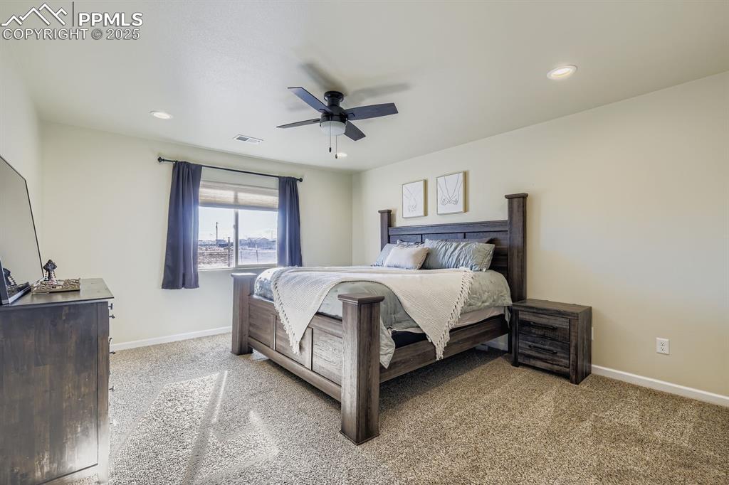 Image 12 of 23: Bedroom with light carpet, a ceiling fan, and recessed lighting