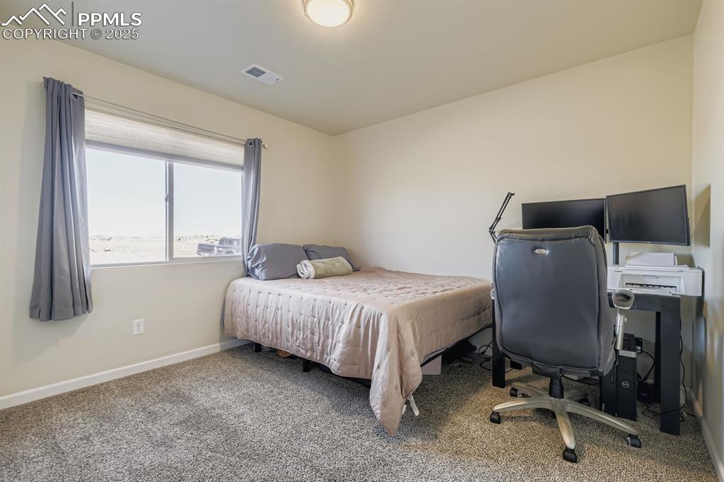 Image 16 of 23: Bedroom featuring carpet flooring and an office area