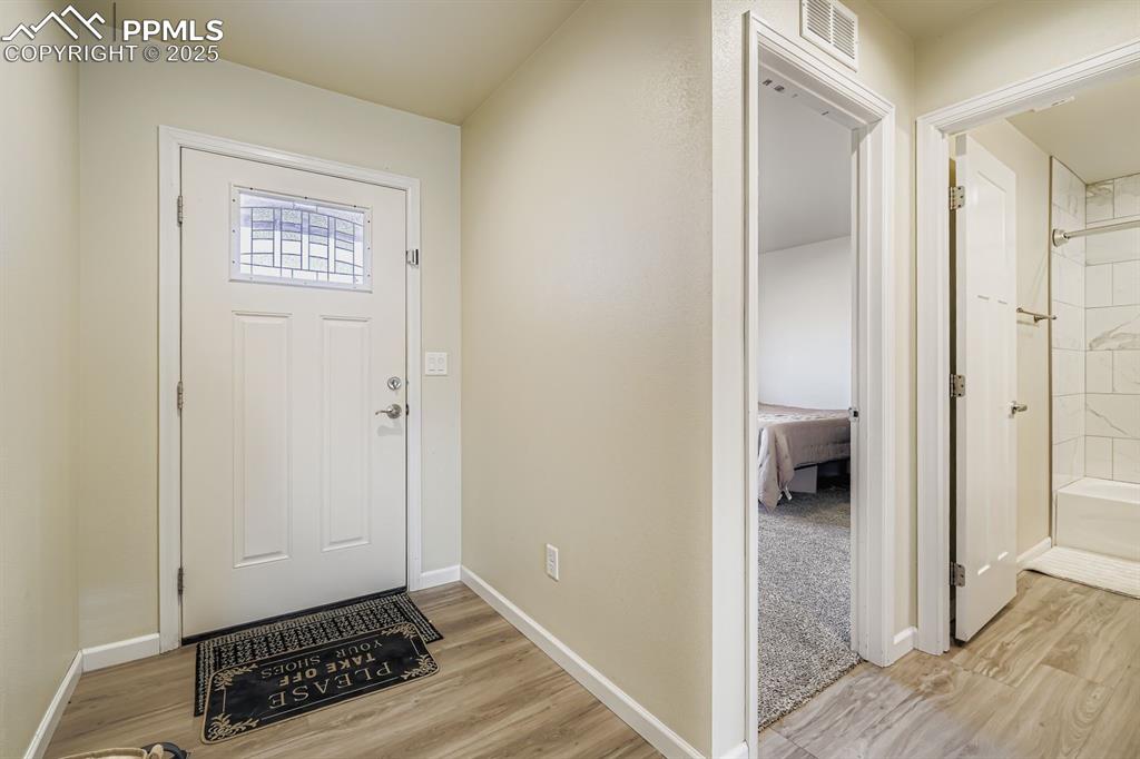 Image 3 of 23: Foyer with light wood finished floors