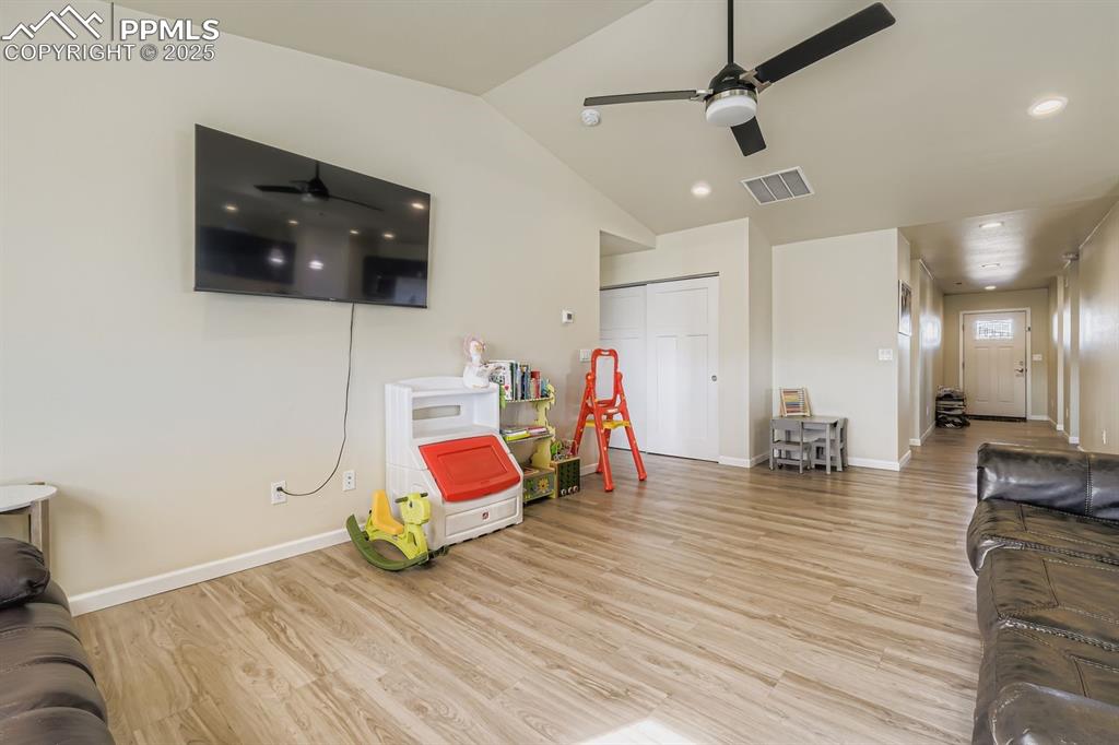 Image 6 of 23: Playroom featuring light wood finished floors, a ceiling fan, and lofted ce