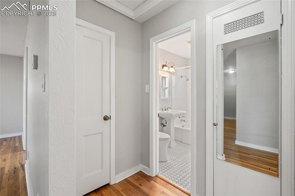 Image 13 of 26: Hall to Bathroom