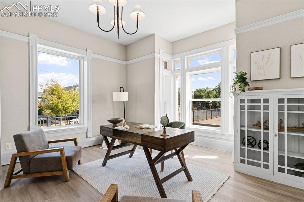 Image 19 of 50: Office featuring a chandelier, light wood-type flooring, and baseboards
