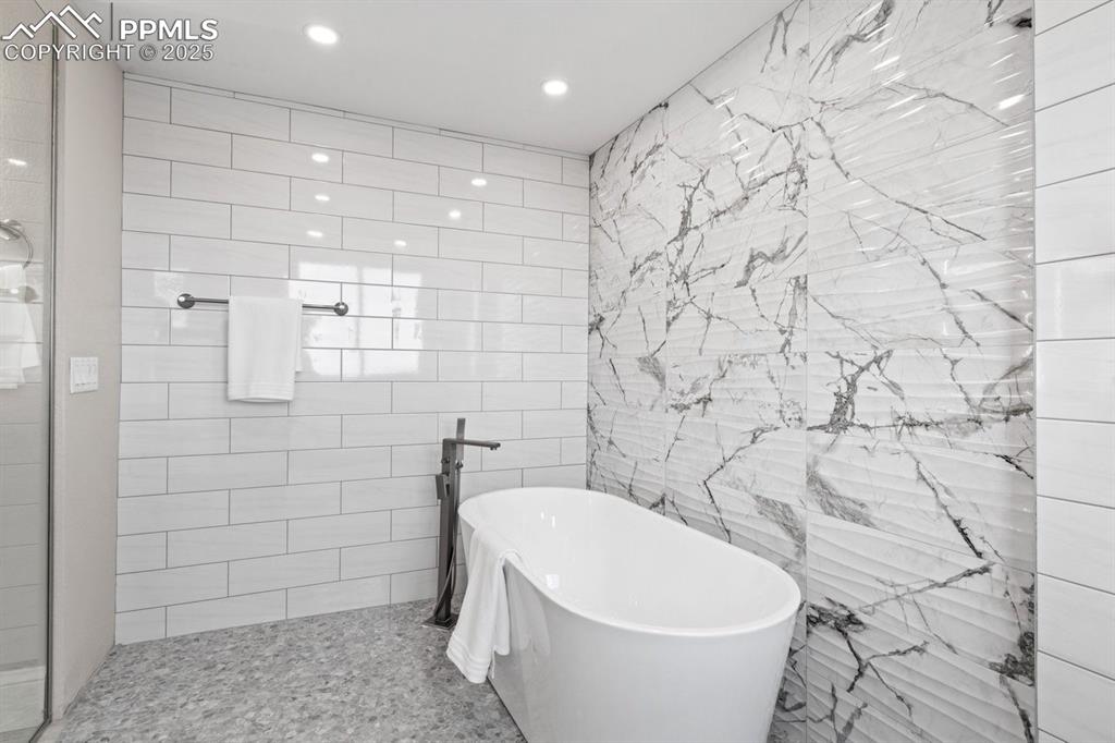 Image 36 of 50: Bathroom featuring a soaking tub and recessed lighting