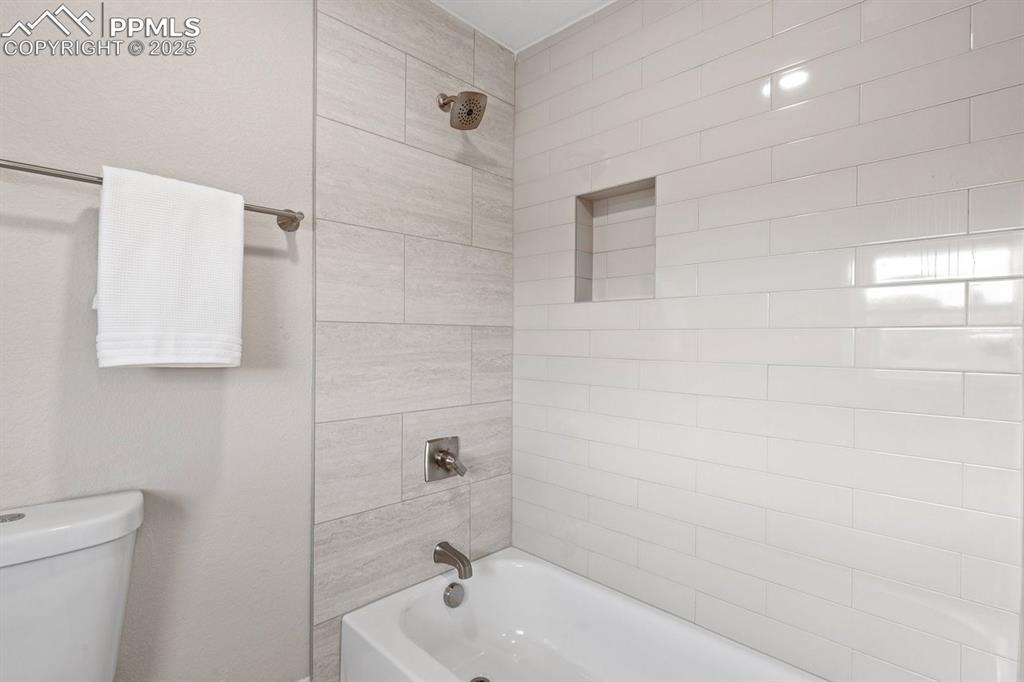 Image 41 of 50: Full bath with  shower combination and toilet