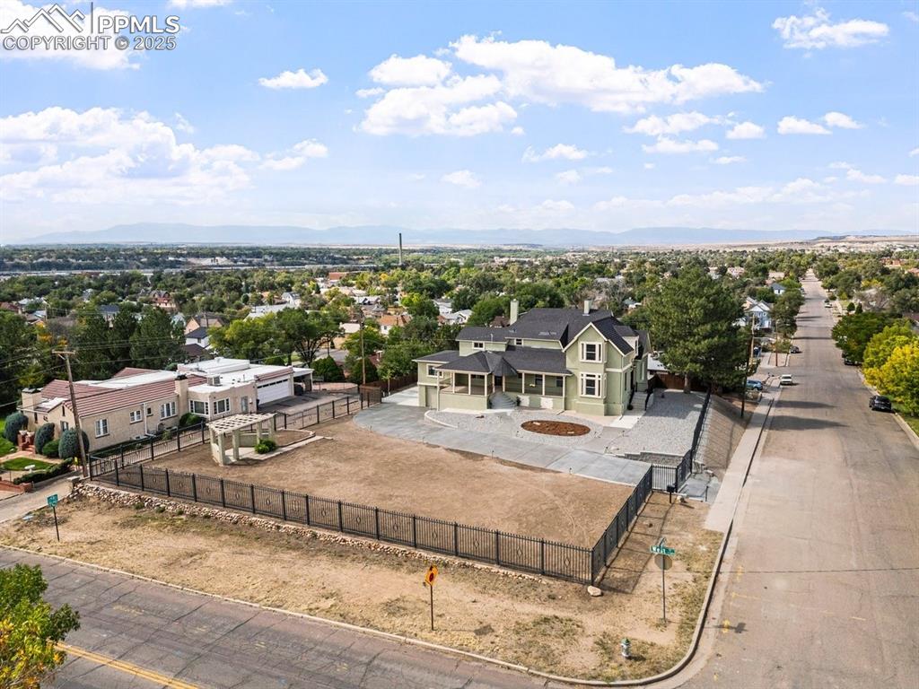 Image 47 of 50: Aerial view of residential area featuring mountains