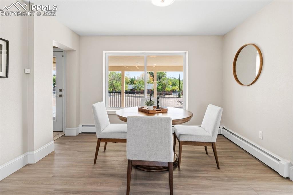Image 7 of 50: Dining room featuring baseboard heating, light wood-style floors, and baseb