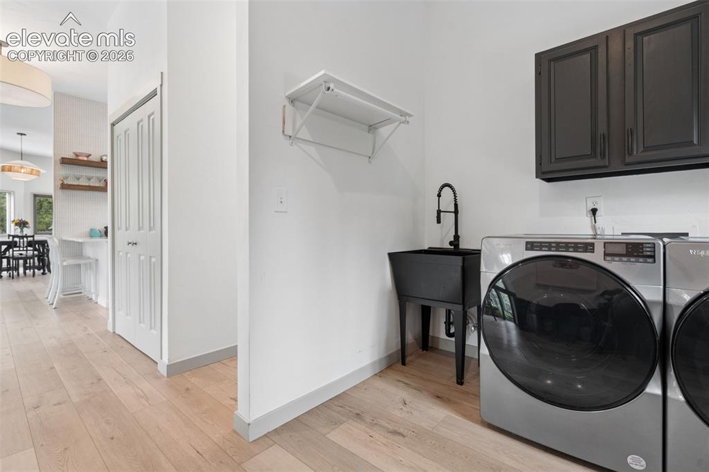 Image 16 of 50: Utility sink and view of how it is tucked off the main level areas