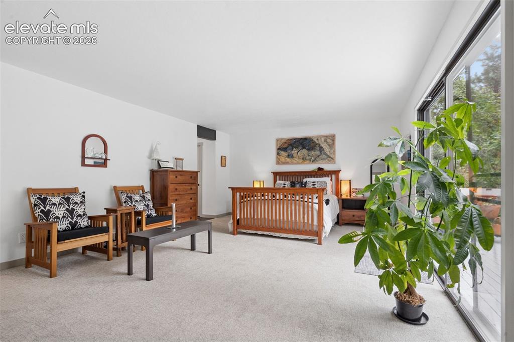 Image 17 of 50: Primary bedroom with walkout to private deck