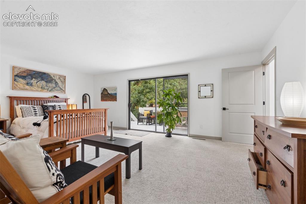 Image 18 of 50: Primary bedroom with walkout to private deck