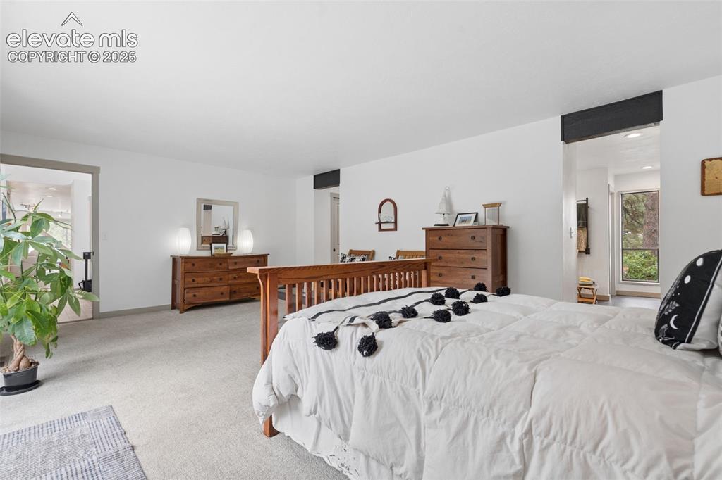 Image 19 of 50: Primary bedroom with walkout to private deck