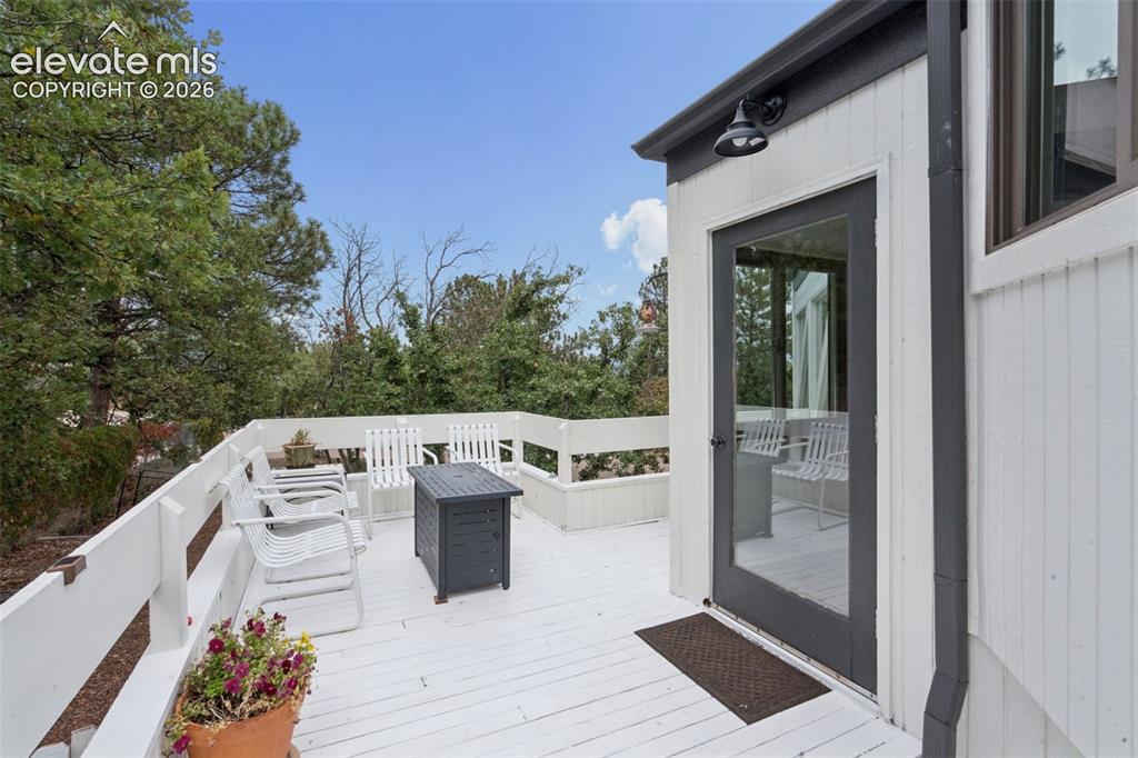 Image 42 of 50: huge side deck to enjoy with access into the main level living room