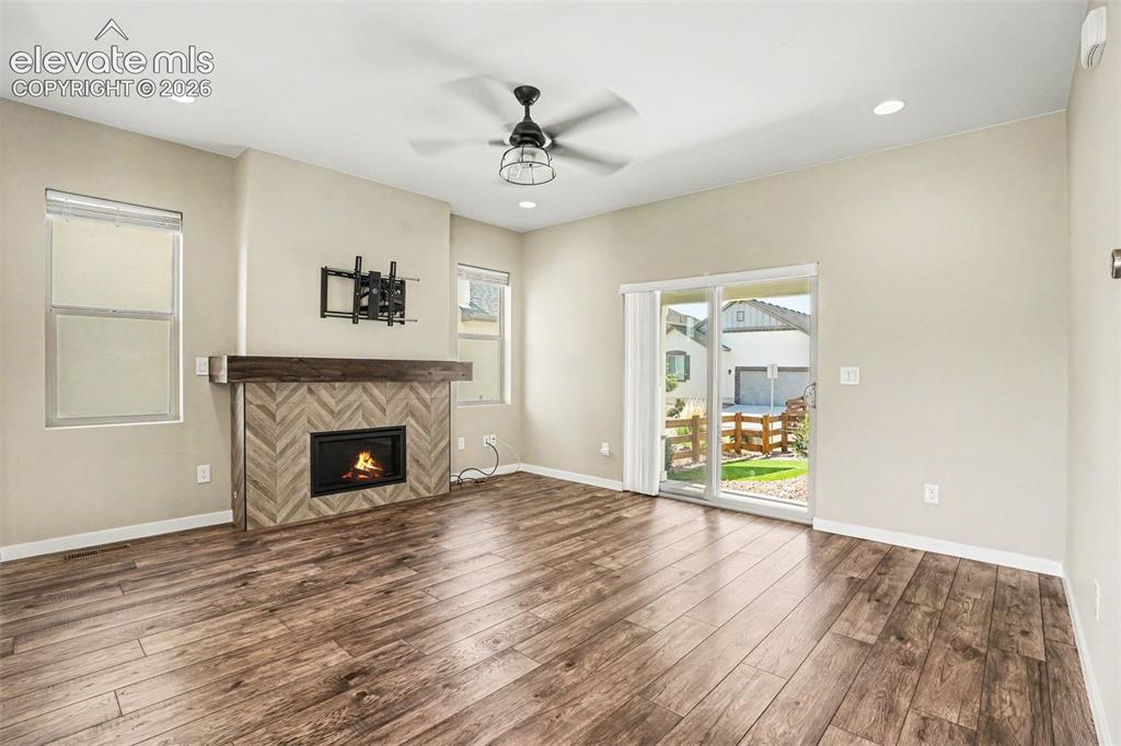 Image 4 of 27: Contemporary two-story stucco residence featuring a covered front porch wit